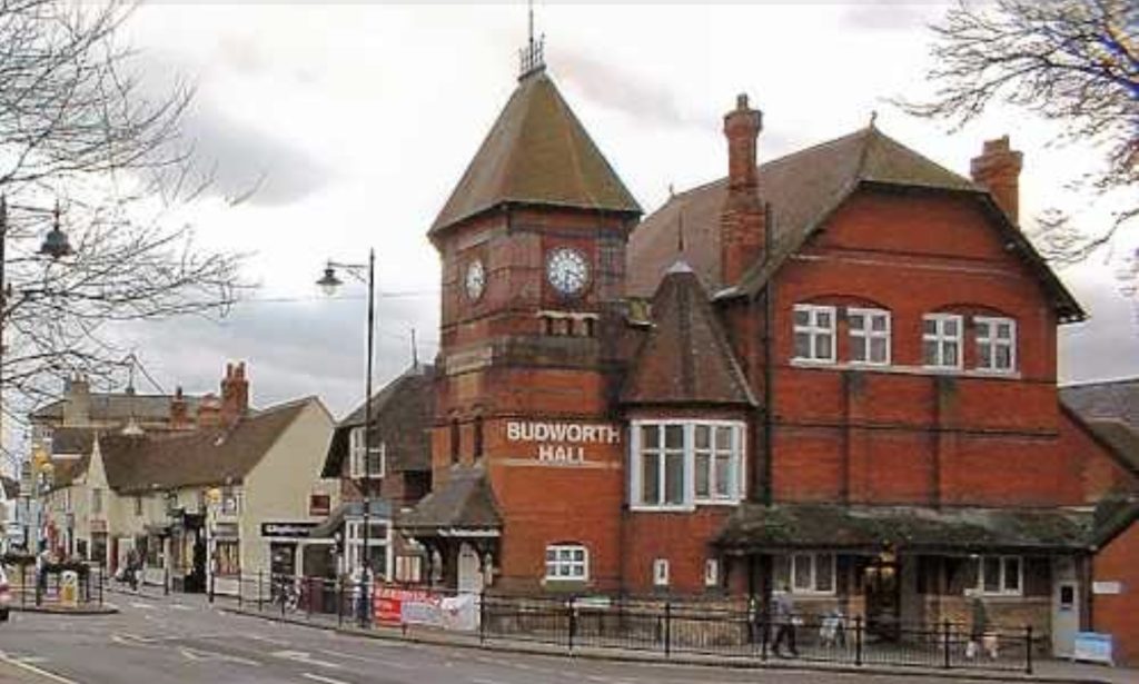 A streetscape in Ongar town centre showing the Budworth Hall