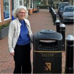 Councillor Elizabeth Jerrard standing next to a waste bin